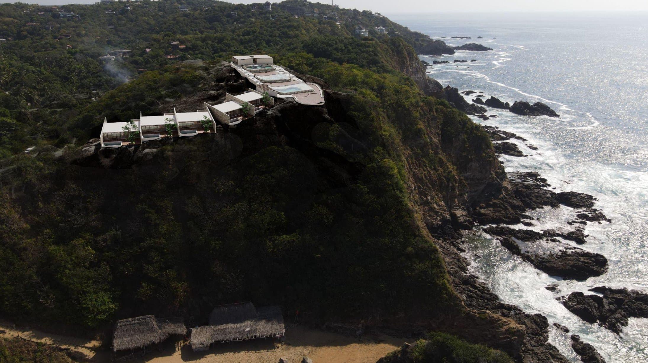 Aerial view of a 2Can Homes residence perched on a cliff above the ocean